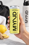 Hand holding a yellow can of MYND Lemon Ginger sparkling protein water with 20g whey protein isolate.