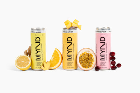 Four MYND energy drink cans with fruit symbols on a white background